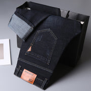 Men’s Straight-Leg Denim Jeans – Mid Waist Casual Washed Trousers for displayed on a black bag.
