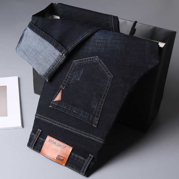 Men’s Straight-Leg Denim Jeans – Mid Waist Casual Washed Trousers for displayed on a black bag.